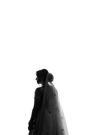 Minimalist black and white silhouette of a bride with flowing veil.