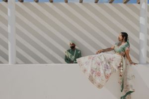 Traditional wedding attire photographed against modern architectural white walls and angular shadows.