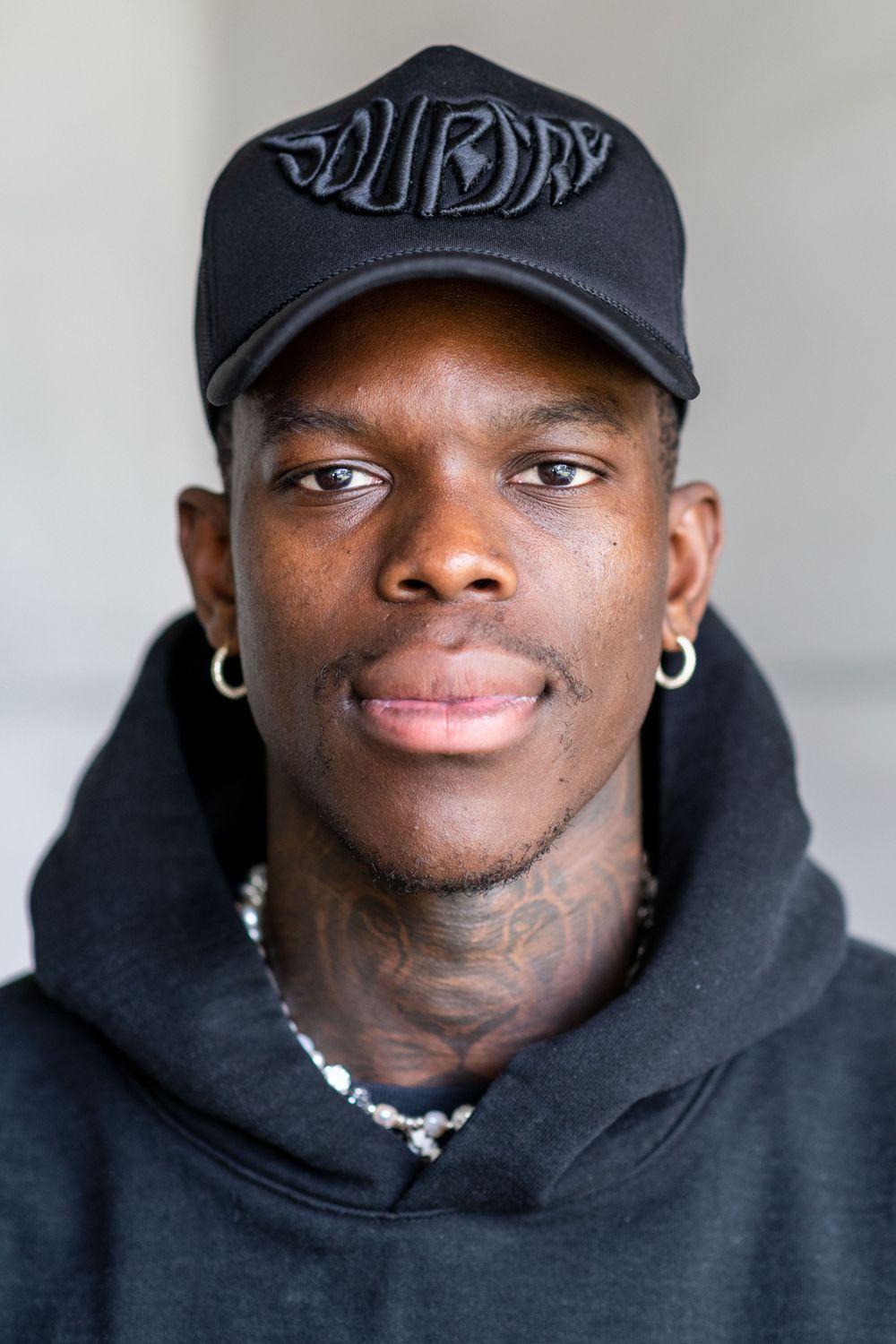 A black man looks at the camera while having his picture taken by a professional photographer in Los Angeles California