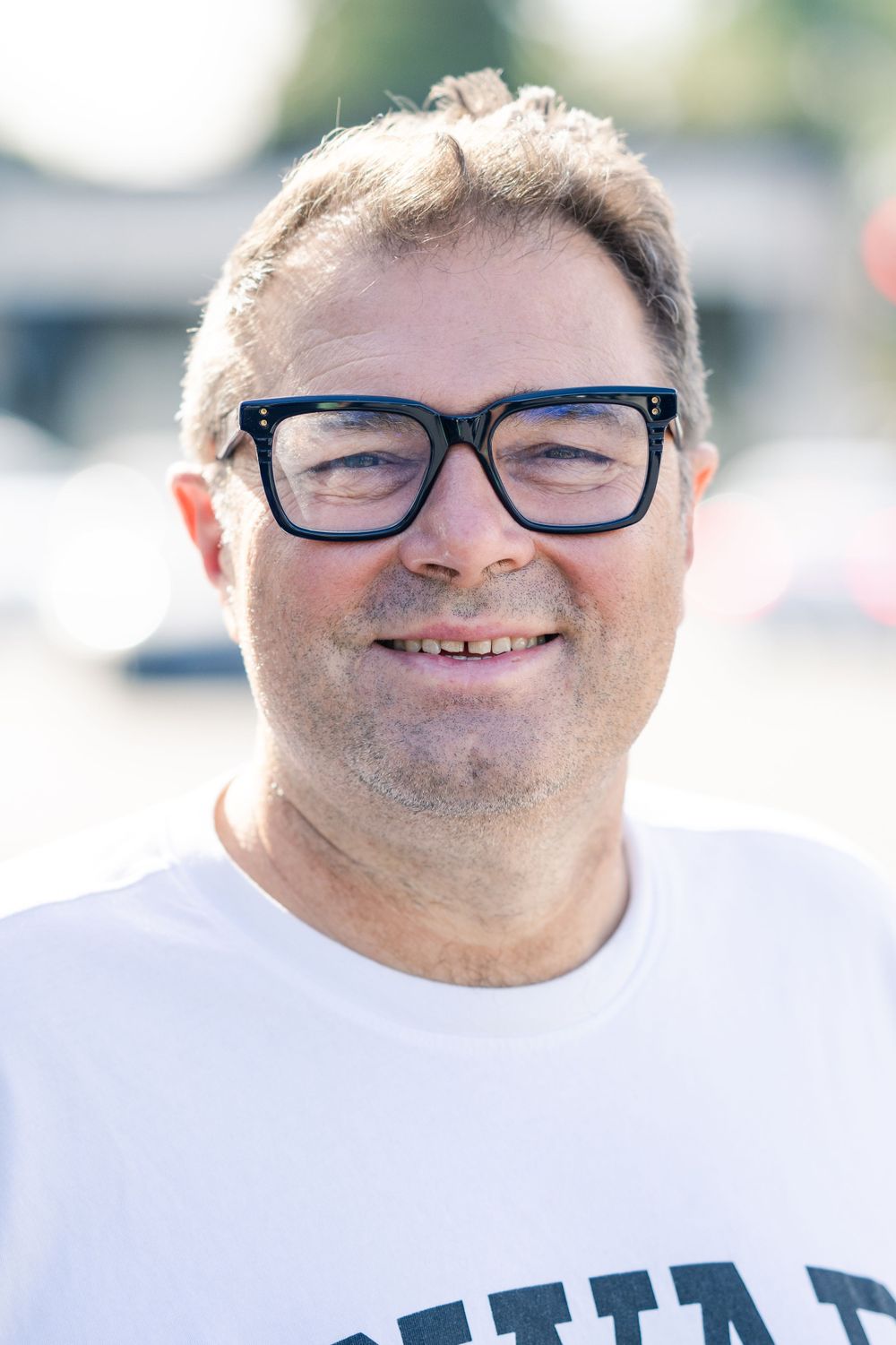 A man with glasses has his portrait taken by a professional portrait photographer in Venice Beach in SoCal