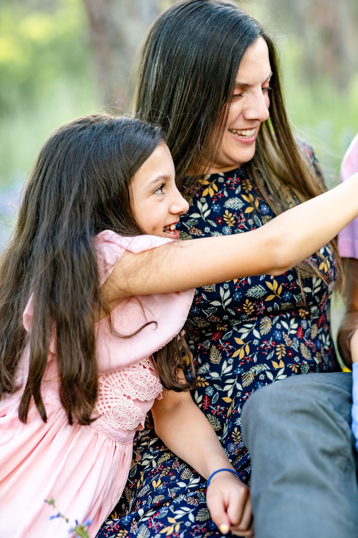 Young girl offers her dad a flower to smell during their family session in Colorado Springs.