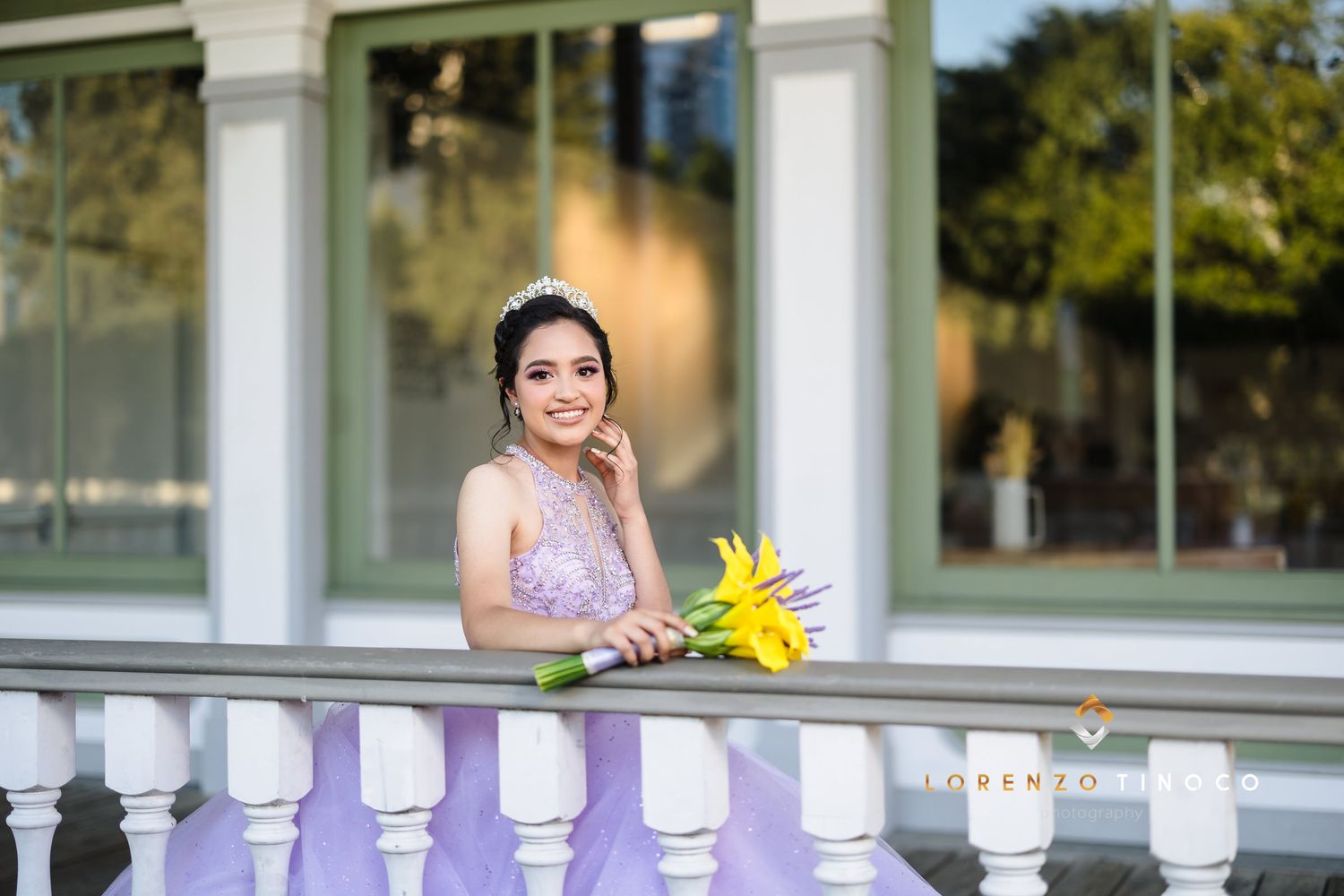 A spring portrait at a classic balustrade with yellow flowers and elegant formal attire.