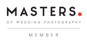 Masters of Wedding Photography member logo in black and red text on white background.