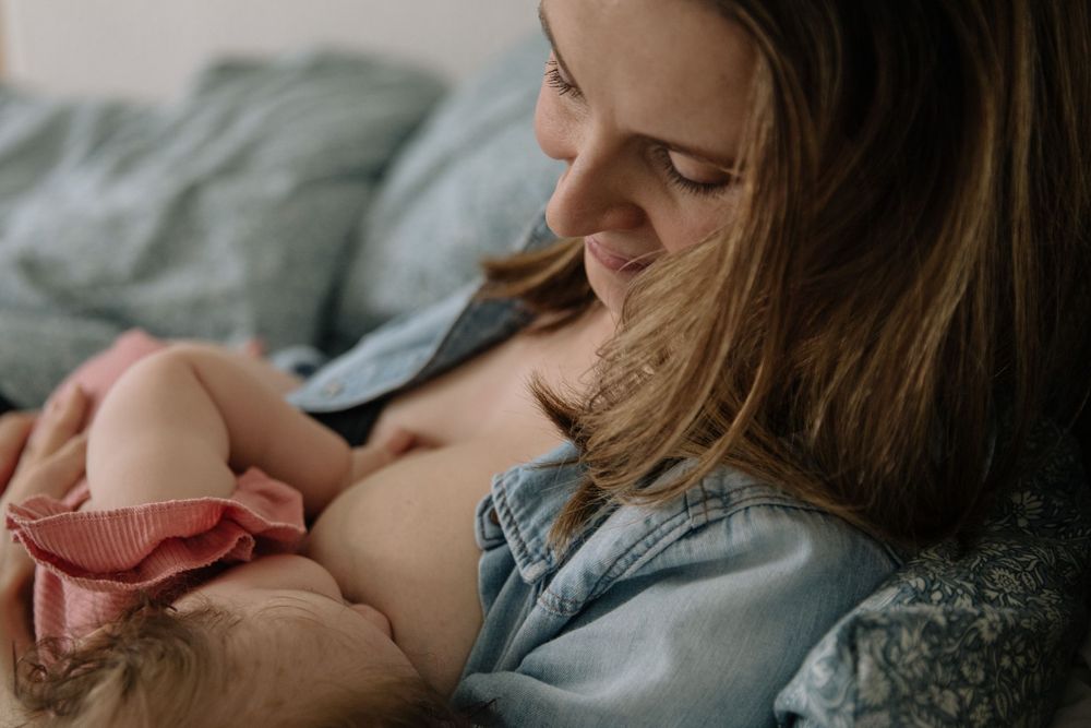 An intimate moment of comfort and connection on a gray couch.