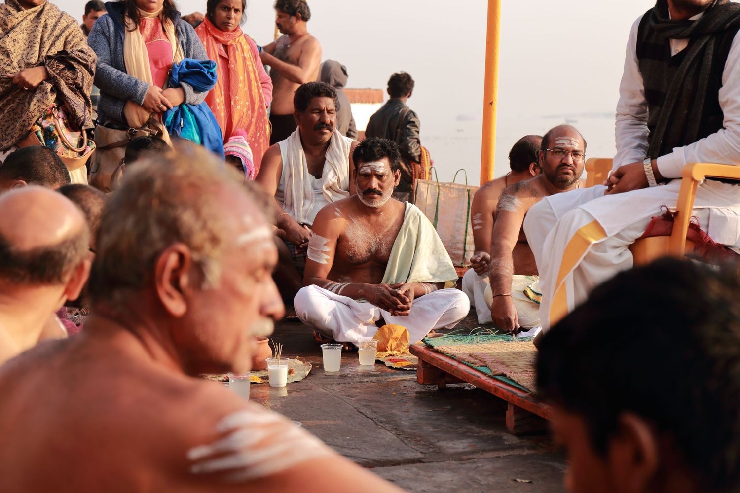 Spiritual gathering on the ghats of Varanasi during a traditional ceremony.