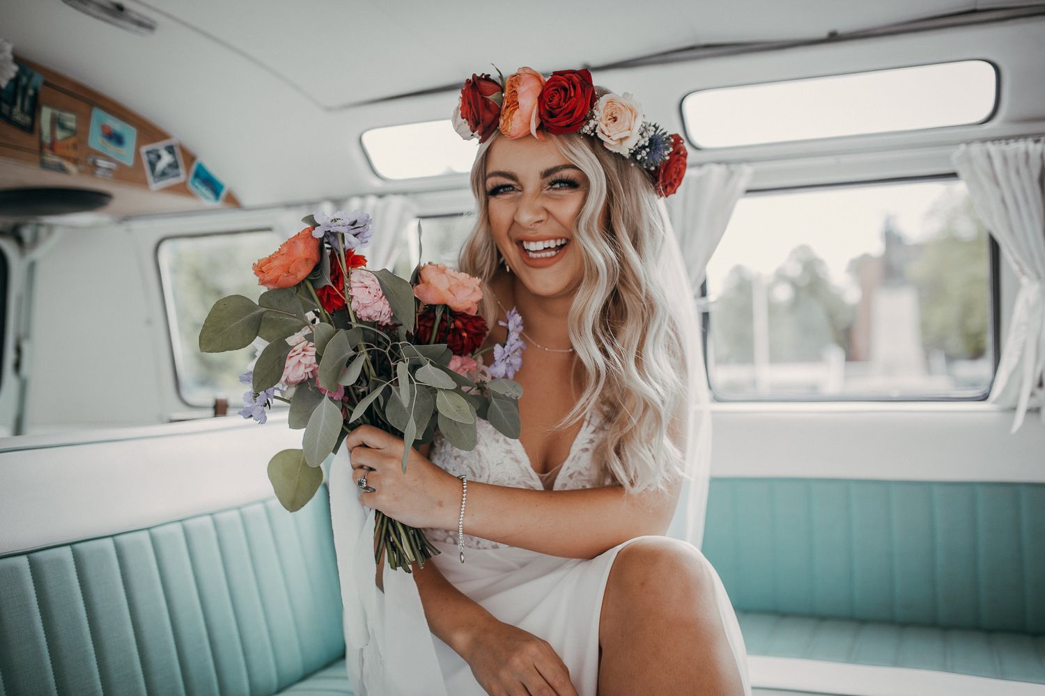 Wedding party posing inside a vintage turquoise Volkswagen van.