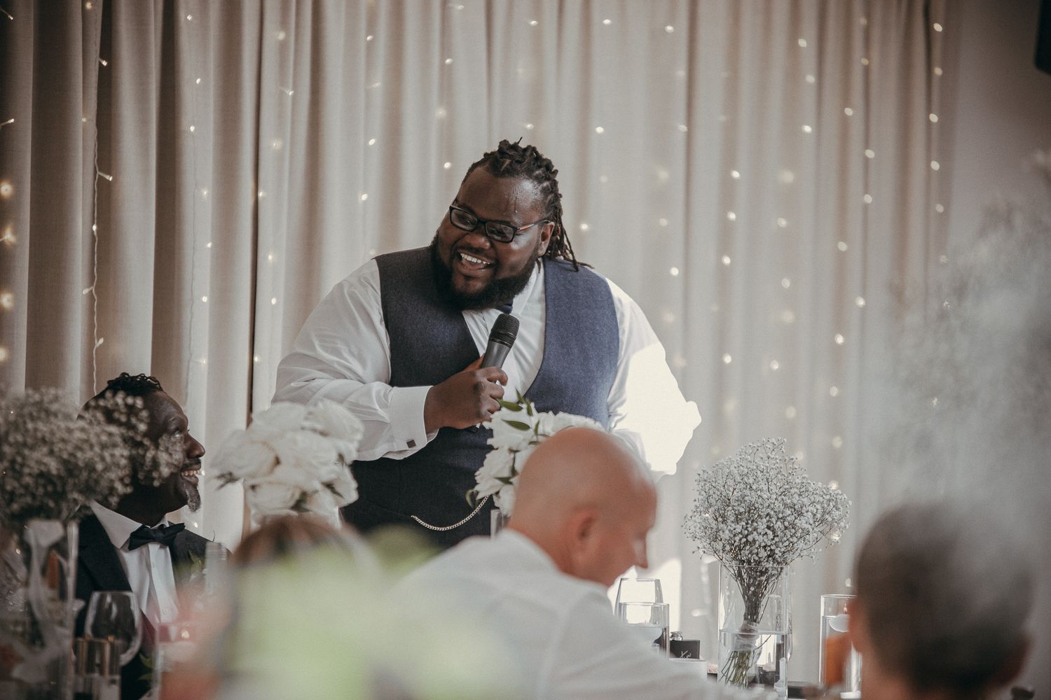 Wedding reception celebration with fairy lights creating a magical atmosphere.