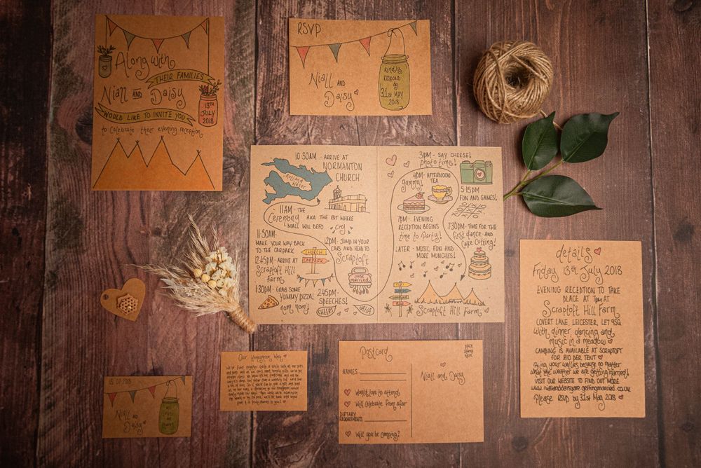 Collection of handwritten kraft paper notes and drawings arranged on wooden background.