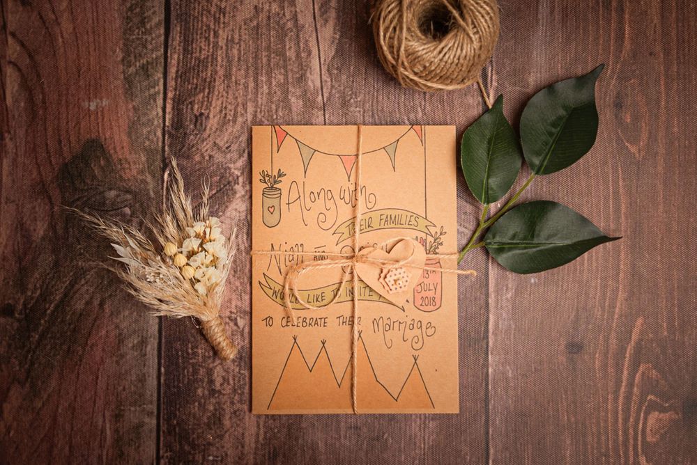 Wedding planning sketch with bunting design on kraft paper with twine and greenery.