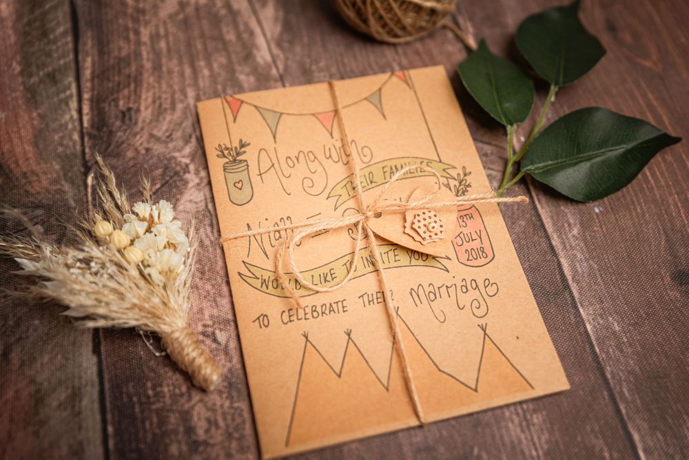 Hand-drawn wedding design sketches on kraft paper with dried wheat stems and leaves.