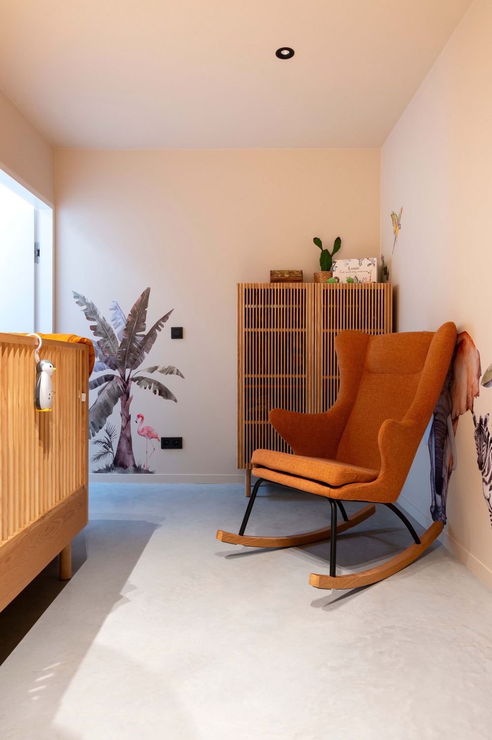Cozy reading nook with orange wingback chairs and wooden screen dividers.