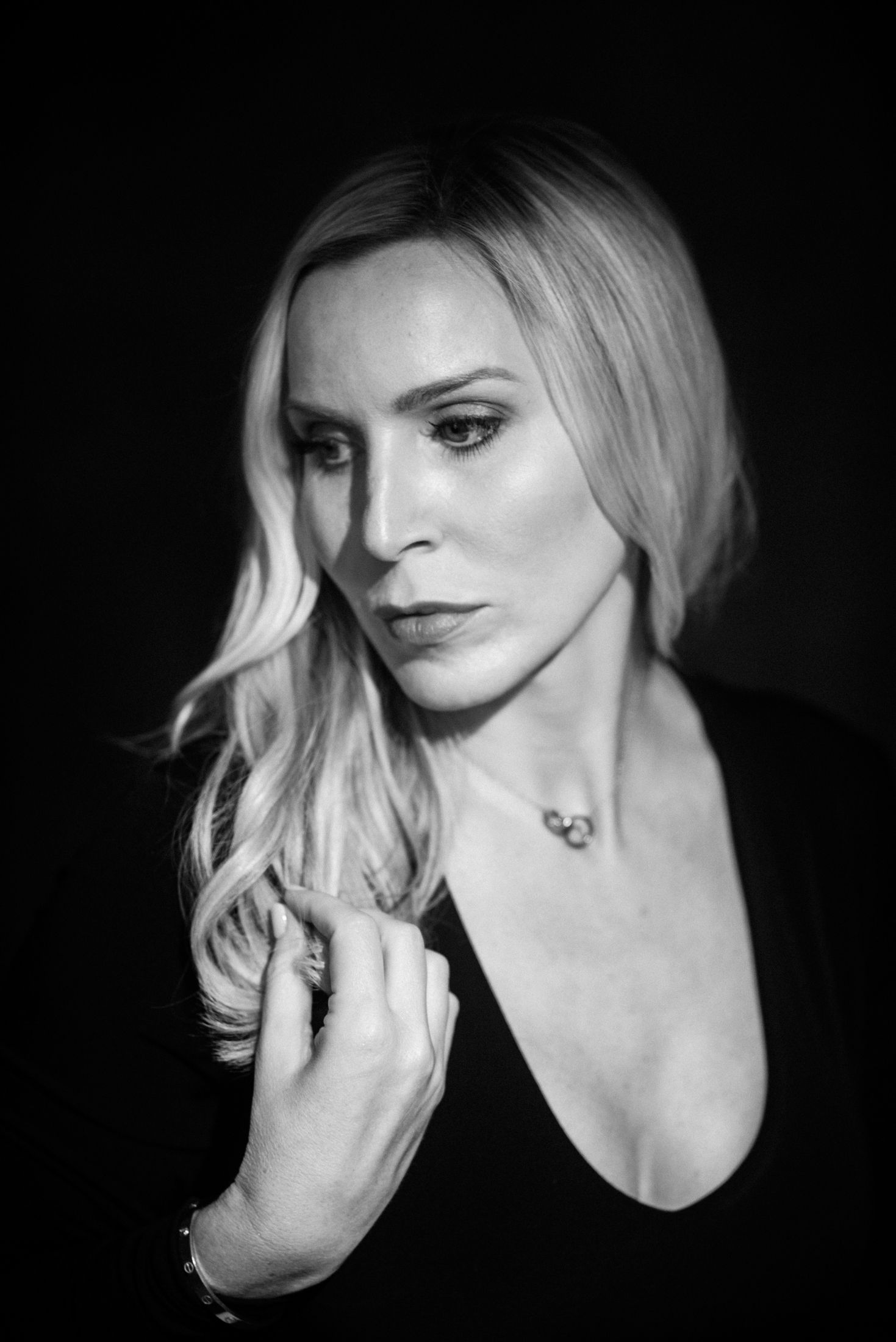 Artistic black and white portrait series with dramatic lighting and shadows.