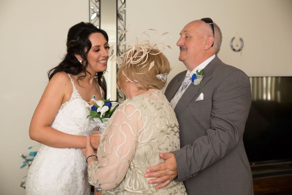 Wedding party gathering in formal attire during celebration.