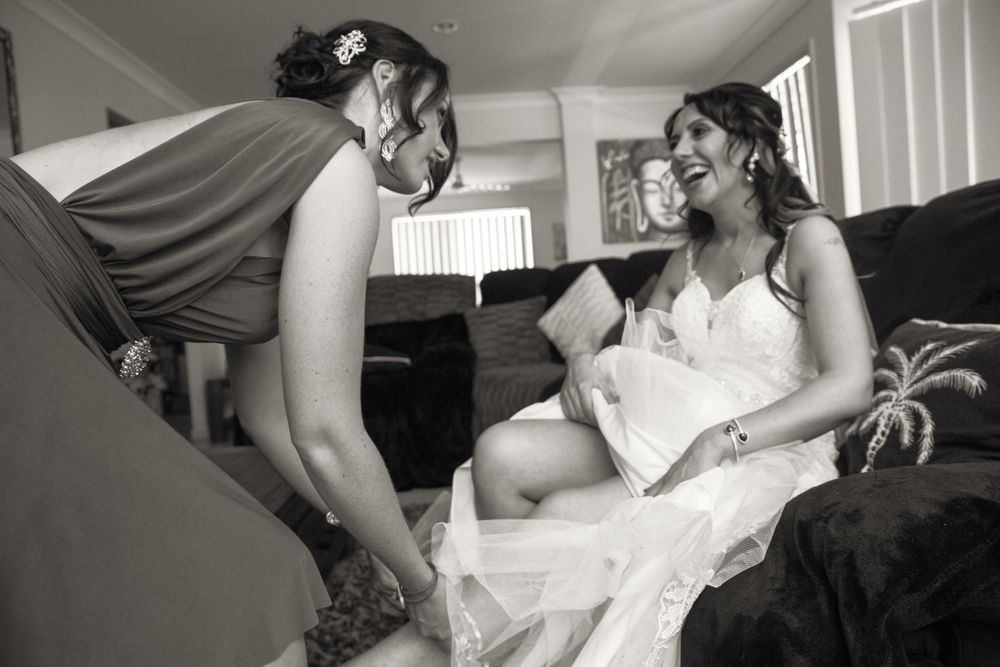 Endearing candid moments between a couple in wedding attire sharing playful interactions during their special day.