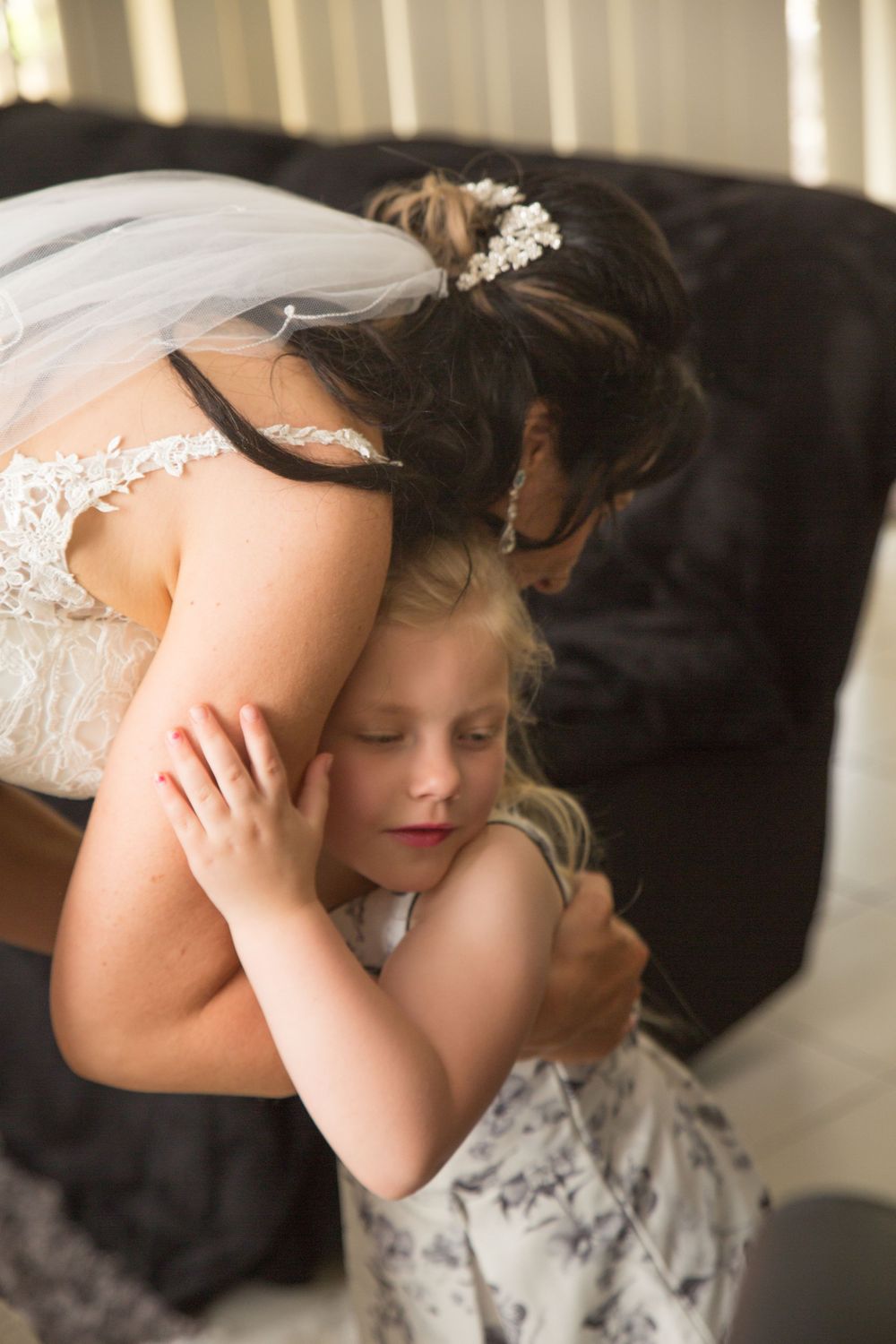 Young child in formal dress resting during a wedding celebration.