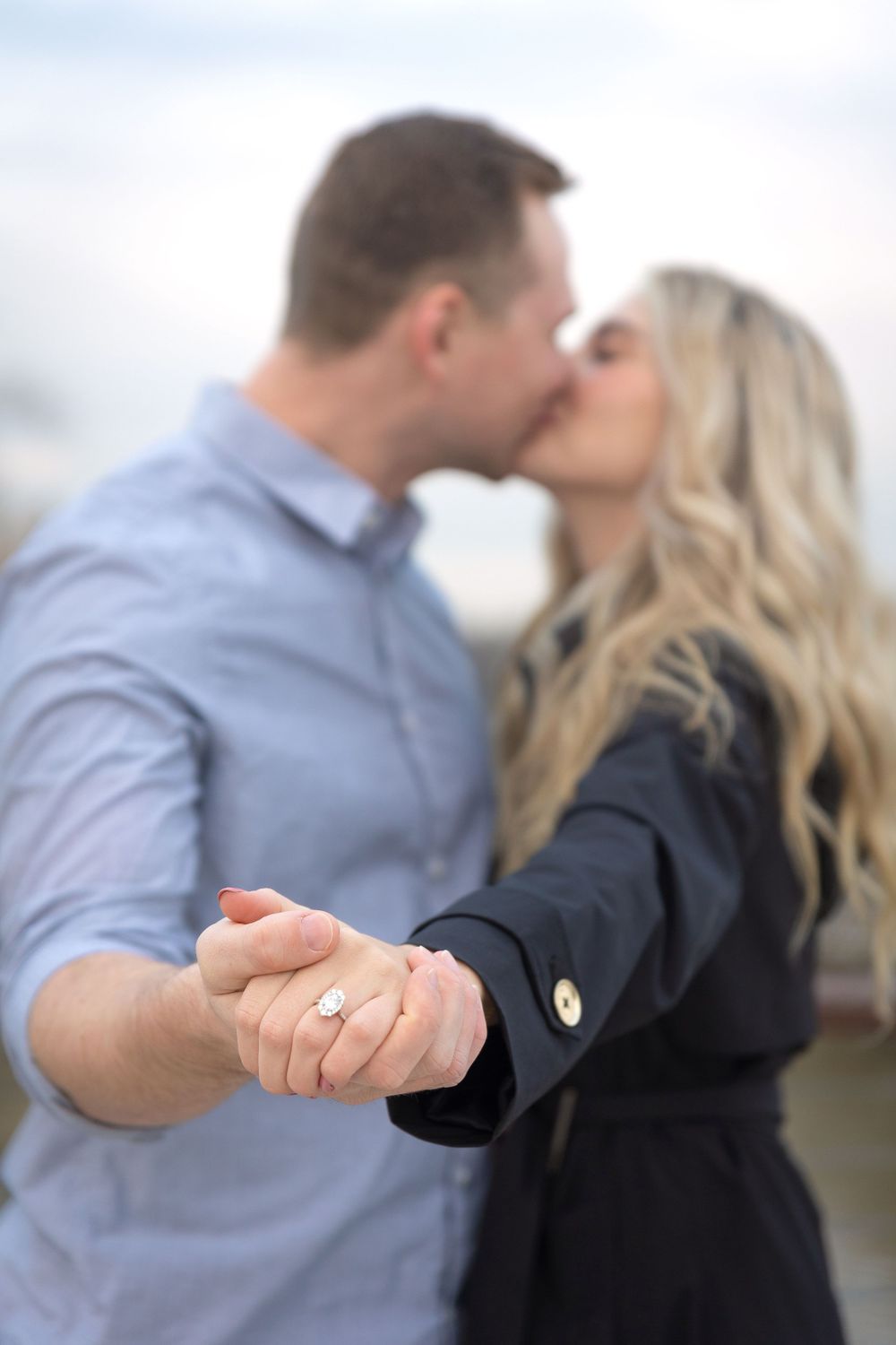 Showing off the new engagement ring after their surprise proposal photoshoot.