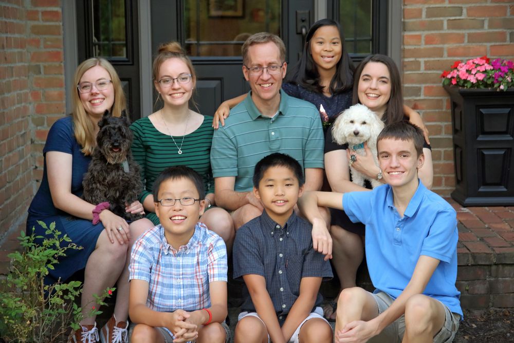 Large family sitting together on porch steps in Columbus Ohio.