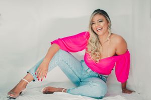 Dynamic fashion poses showcasing pink top and denim outfit combination.