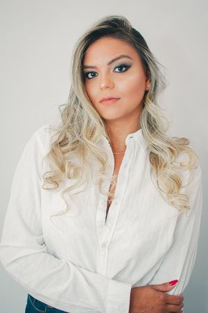 Fashion portraits featuring white button-down shirt and styled blonde hair.