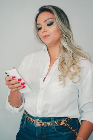 Lifestyle photos showing casual poses with phone and white shirt outfit.