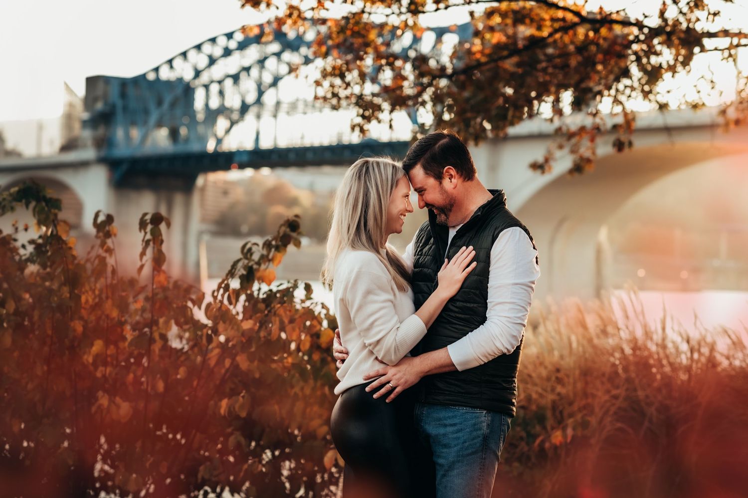 Husband and wife share a moment by the Tennessee River in Chattanooga during photo session in fall
