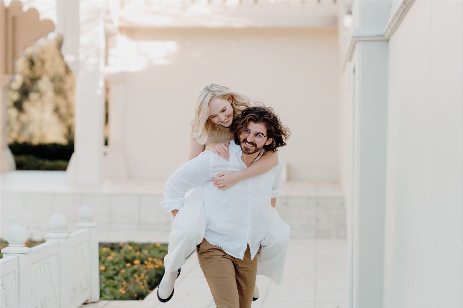 couple laughing while giving a piggyback