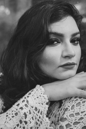 Close-up artistic black and white portrait series showing delicate lace details against skin.