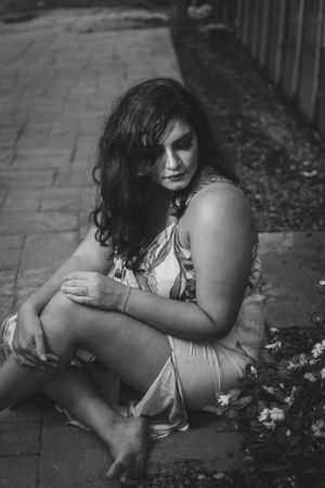 Black and white artistic portrait sequence showing emotional poses on the ground.