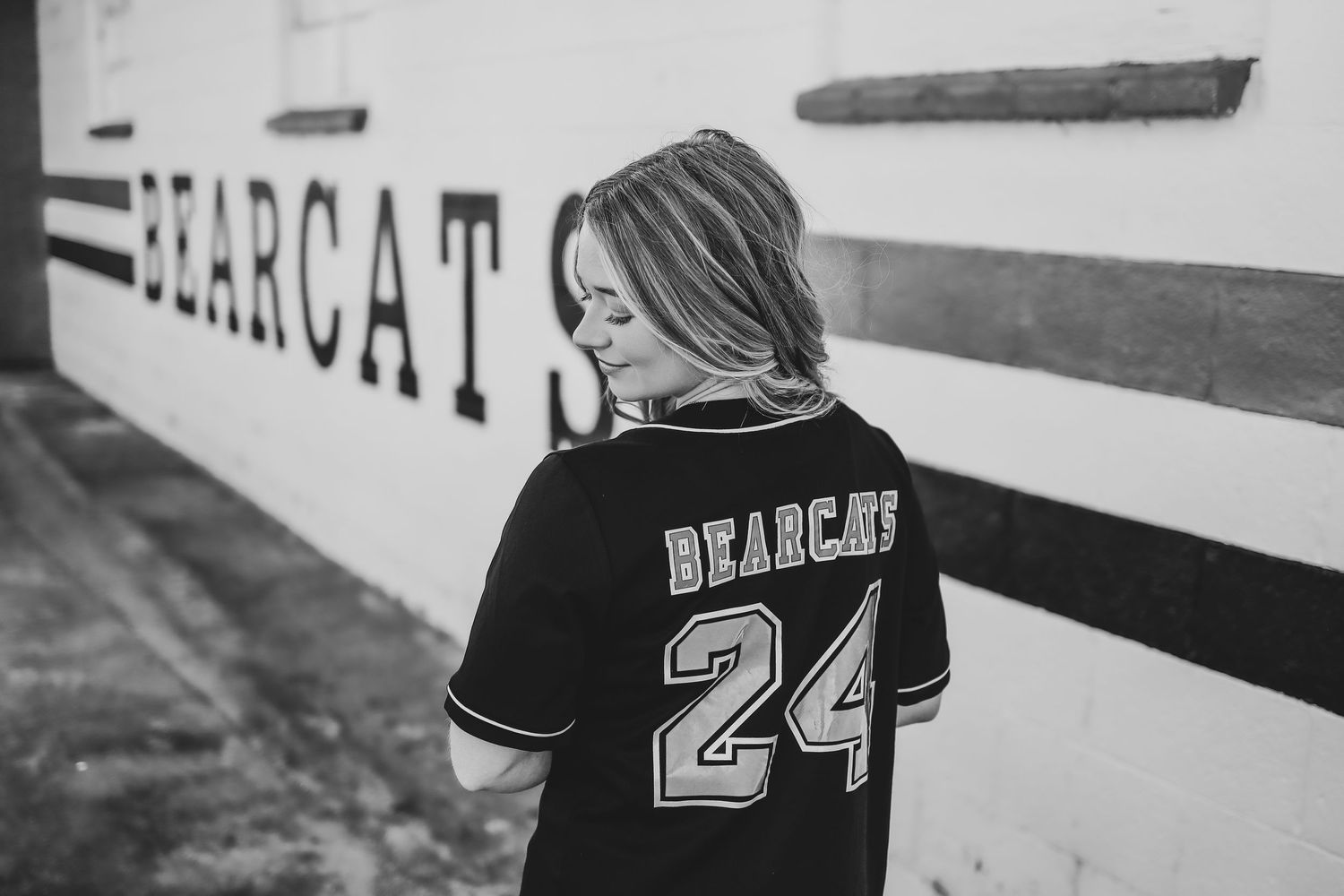 Black and white portrait of person wearing Bearcat jersey number 24.