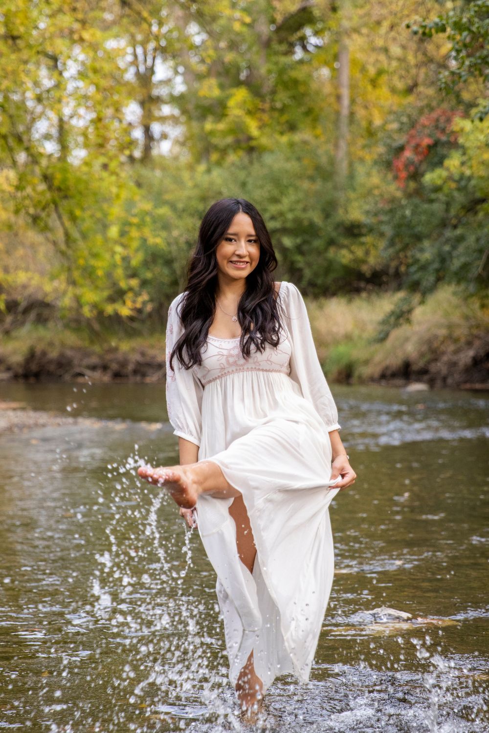teenage girl playing in the river at innovation hills park in Rochester Hills michigan