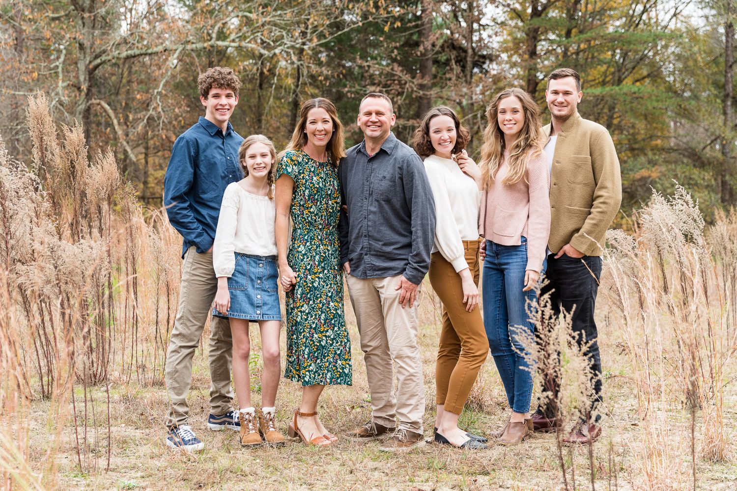 Family posing in tall grass in Autumn at Latta Plantation