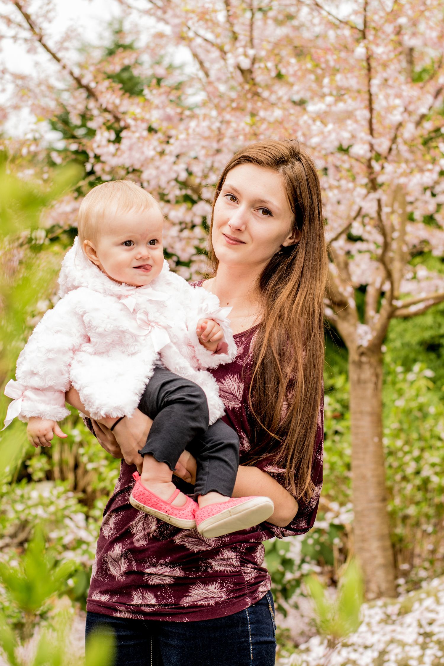 Spring portrait session among blooming cherry blossom trees.