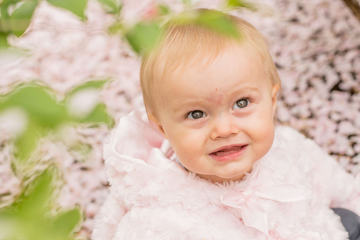 Spring portrait with cherry blossoms in soft pink tones.