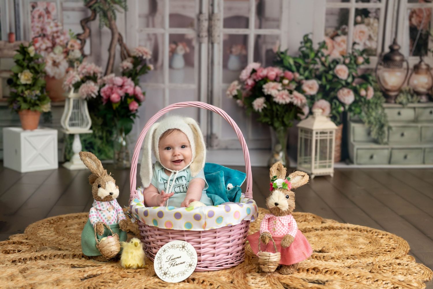 Easter basket setup with decorative bunnies and spring flowers in a vintage-styled indoor setting.