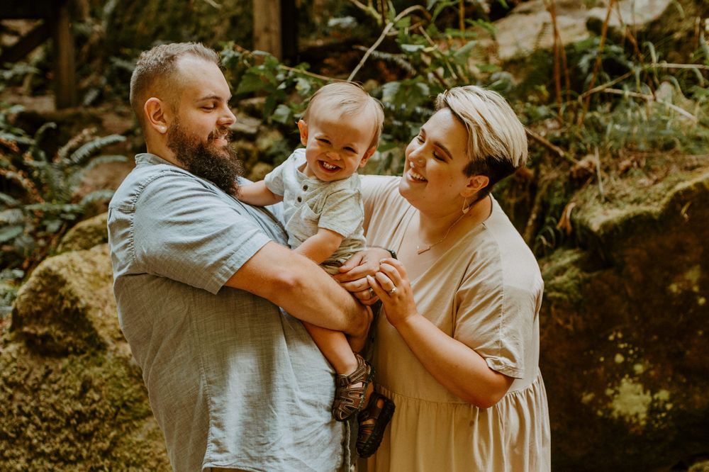 Loving family moment shared during a hike through scenic forest terrain.