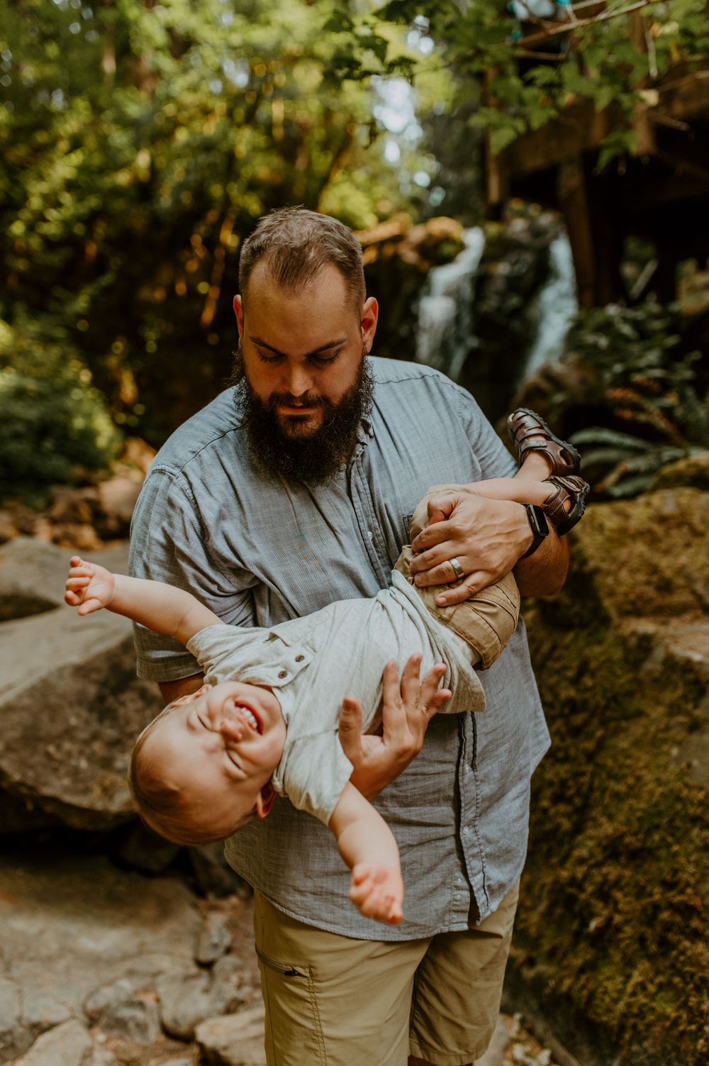 Playful moments captured between parent and child on outdoor hiking trail.