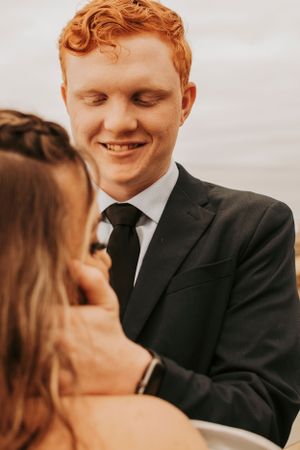 An intimate moment between newlyweds during their seaside wedding photoshoot.
