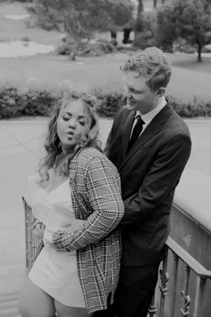 A playful black and white photo sequence of a couple dancing and embracing outdoors.