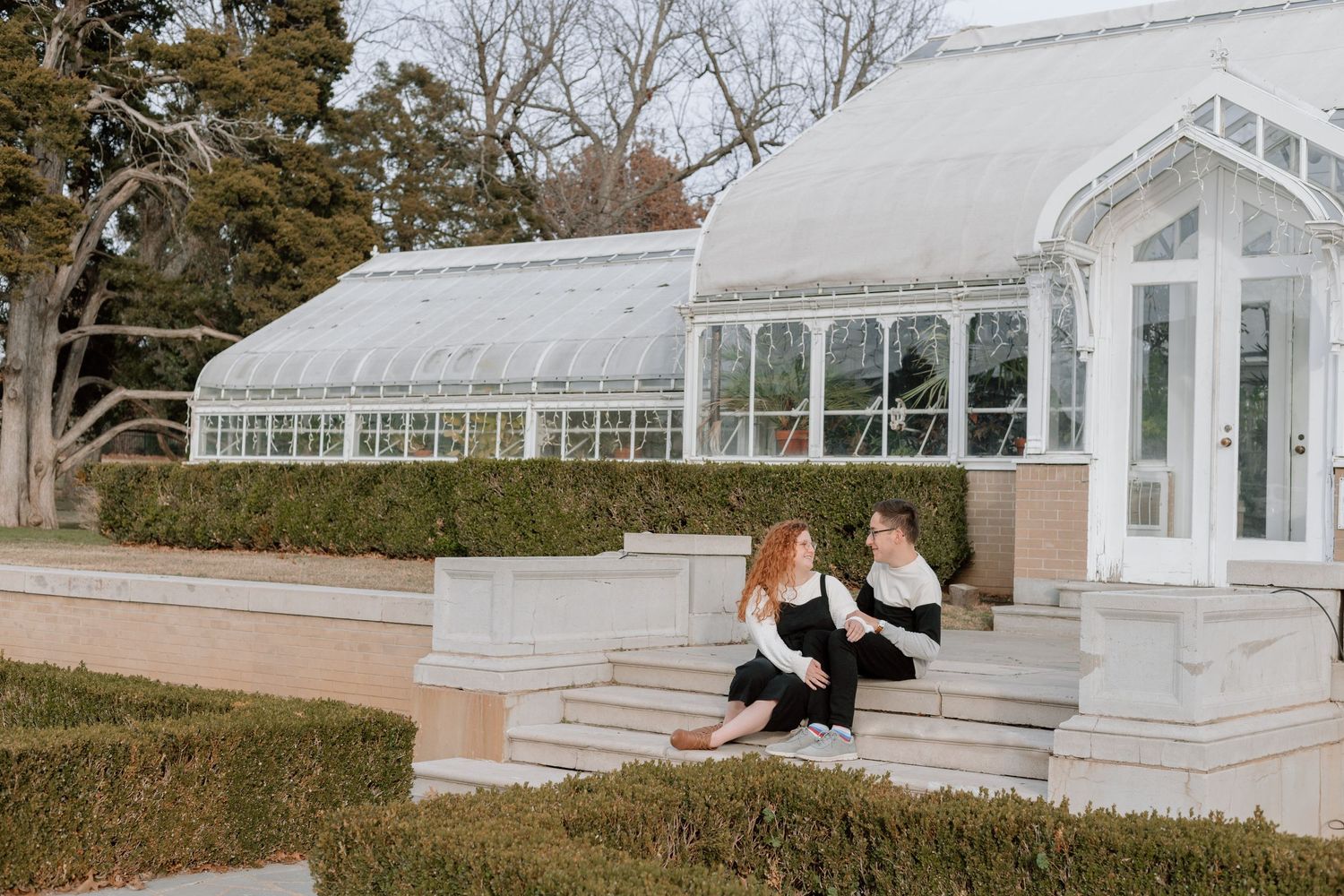 Couple engagement session and portrait photography in Tulsa, Oklahoma with a timeless edit in front of a greenhouse