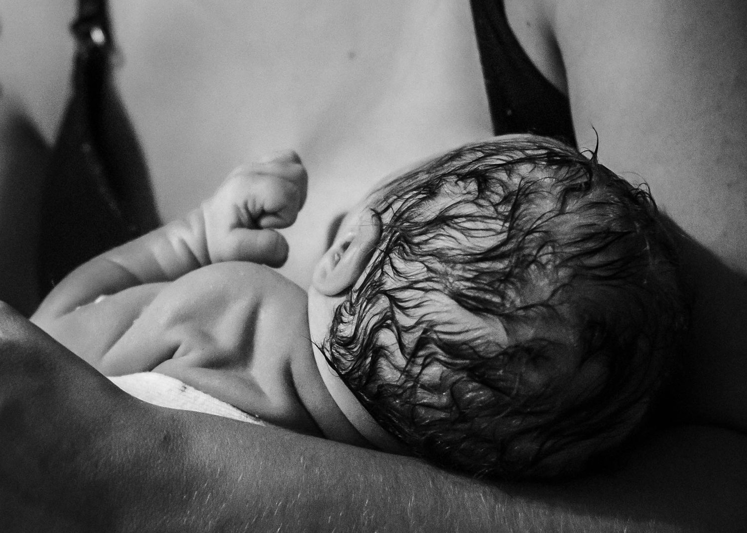 Newborn baby boy held by his mom just minutes after birth in Sioux City, IA.