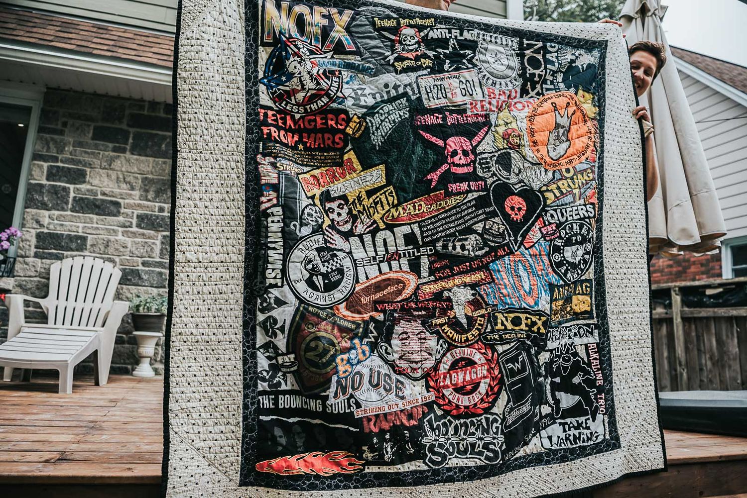 Queen size collage quilt made with punk t-shirts from concerts.