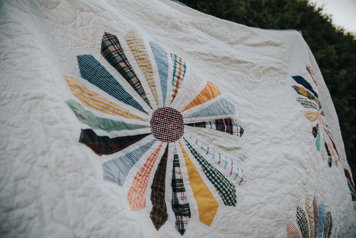 Dresden flower on white Kona fabric, with the flower being made of a mix of dress shirts and ties.