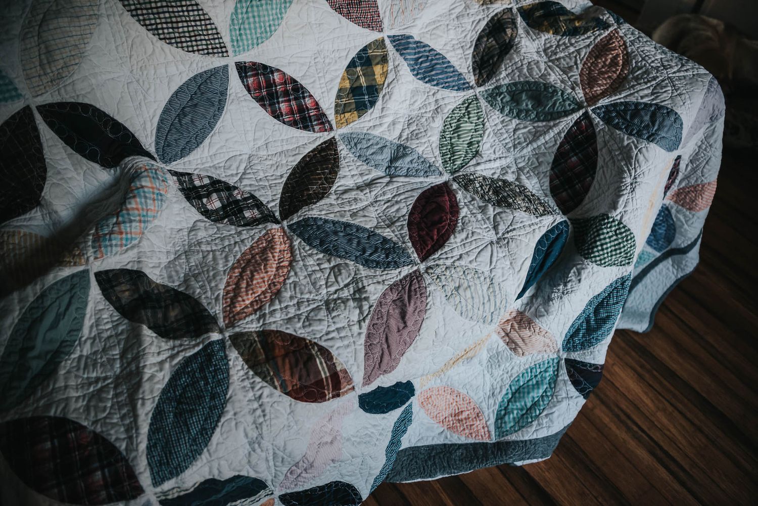 Memorial quilt made with dress shirts and white Kona fabric in an orange peel design.