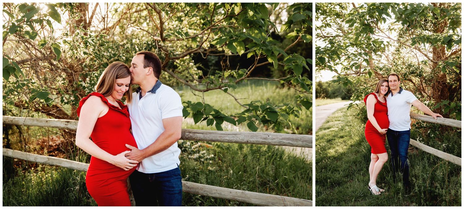 couple posed for maternity photoshoot along a wood rail fence under a tree at sunset