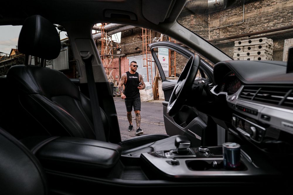 Interior view of luxury car with black leather seats and dashboard.
