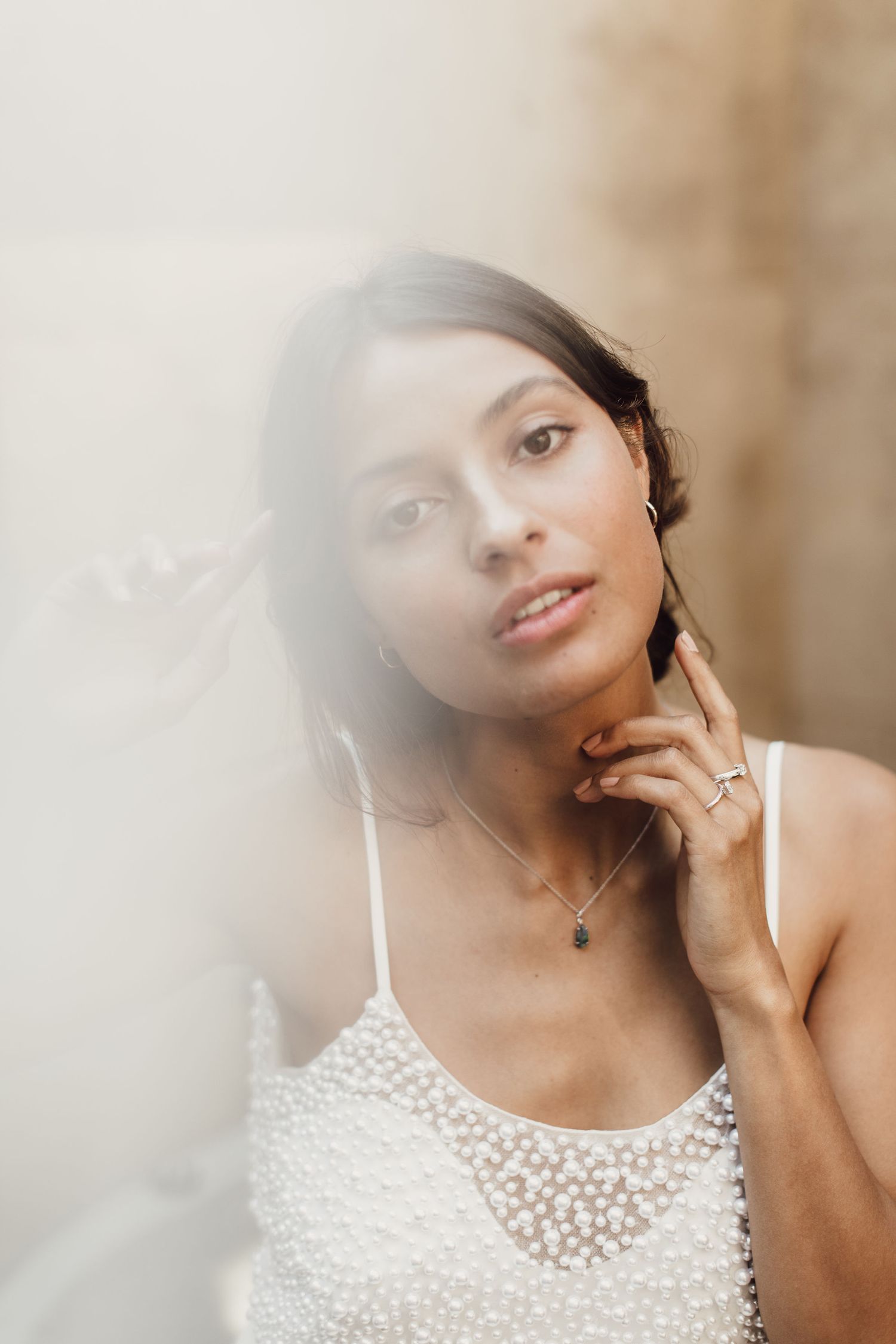 Ethereal bridal portrait with soft lighting and delicate lace details.