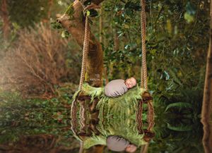 Composite image of baby on a swing in a green forest