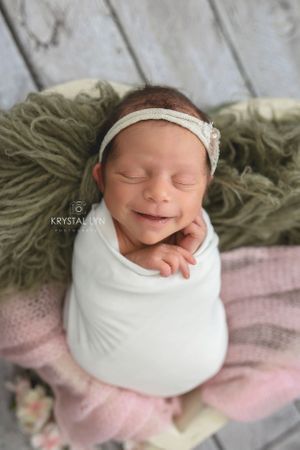 Tiniest baby has huge smile for her photographs