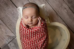 Little sister wrapped and cuddly in red and grey