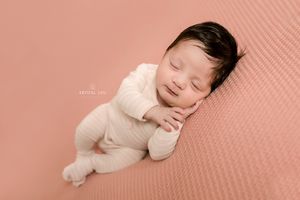 Sleeping girl with so much hair , placing her hand softly on her face